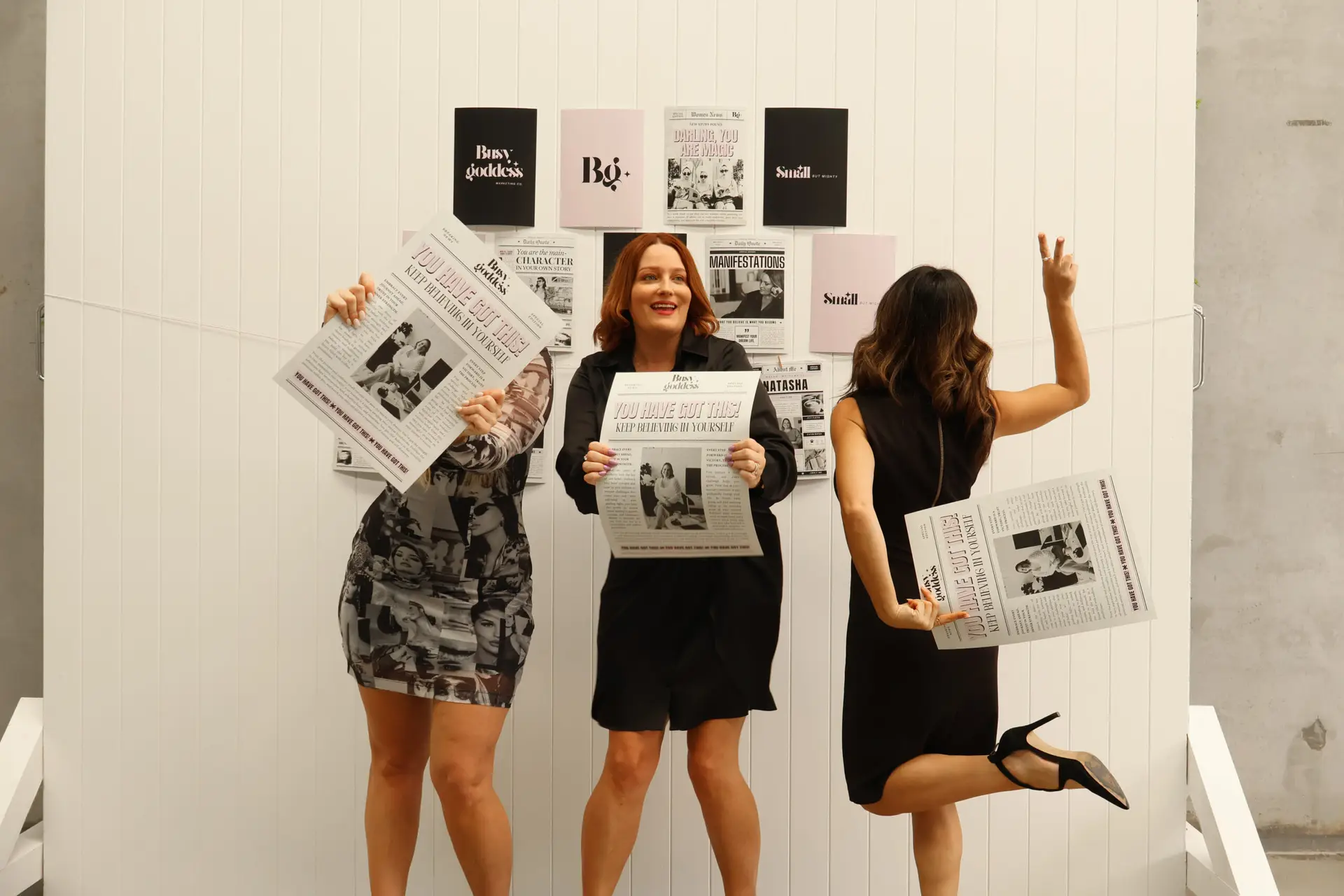 Home | Busy Goddess Marketing | Australia Wide 3 Natasha Panetta founder in front of Get Shit Done sign seated in chair smiling happily