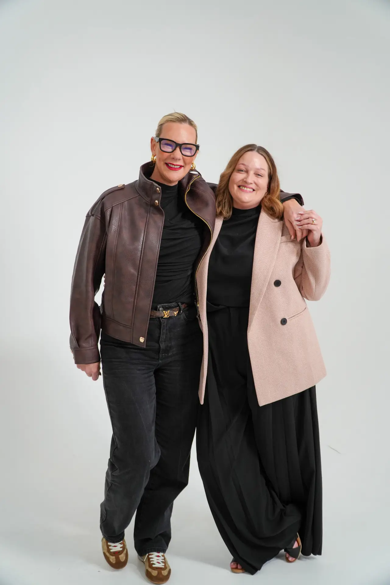 Natasha Founder and Holly Media Smiling in front of white wall